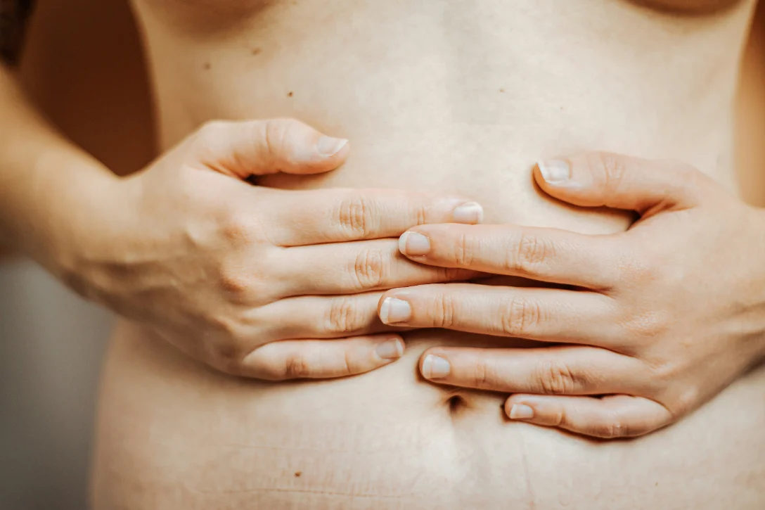 Hände ruhen auf dem Bauch